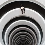 Looking upward through a series of white concentric arches