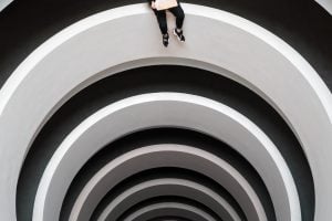 Looking upward through a series of white concentric arches