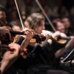 Violinists playing together in an orchestra