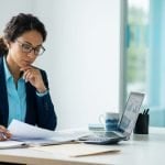 Auditor reviewing documents at a desk