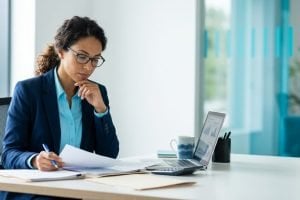 Auditor reviewing documents at a desk