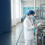Food safety auditor inspecting a production line