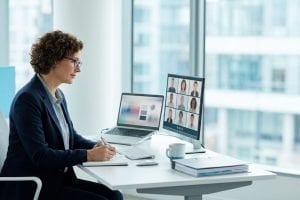 Auditor conducting a hybrid management system audit, reviewing digital evidence on a laptop