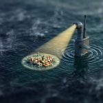 Tilt-shift miniature of a submarine periscope casting a narrow cone of light onto one small island of activity in a vast dark ocean