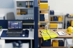 Tilt-shift view of an office desk running an analytics dashboard and a warehouse bench with a hi-vis vest and hard hat, separated by a partition, with a single lit line running across the divide