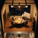 Tilt-shift miniature of an office meeting room at night, a small team working through a data breach response plan at a whiteboard